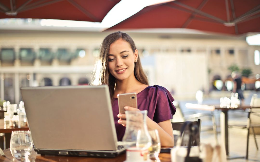 woman looking at phone at table