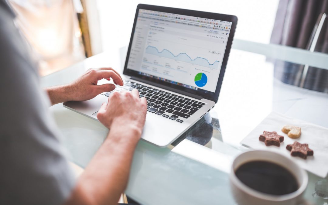 man using google analytics on laptop