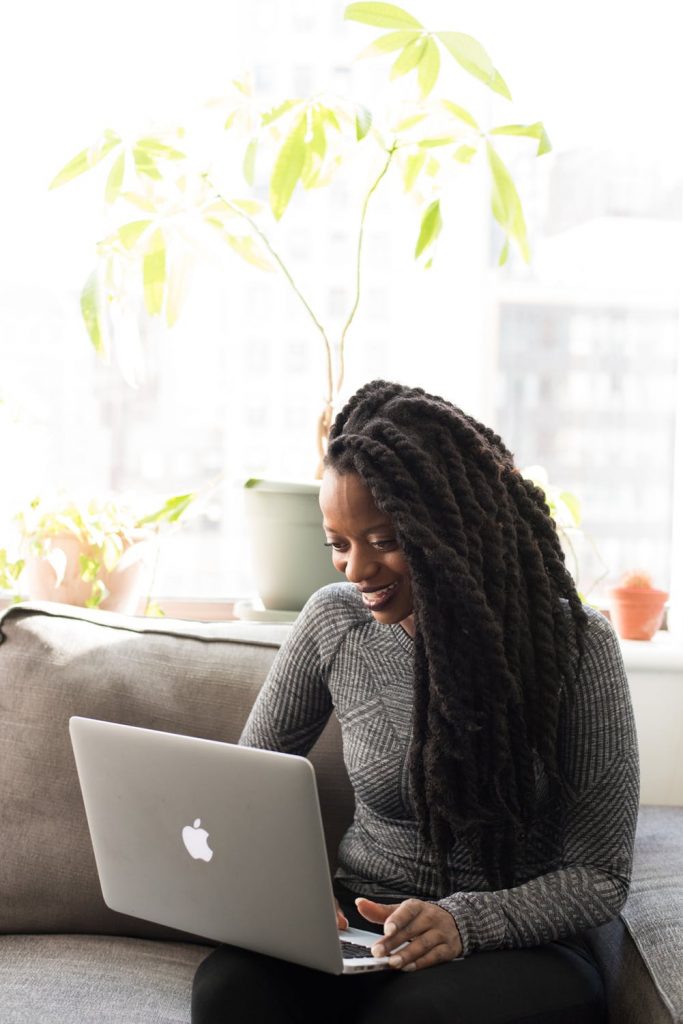 woman smiling using laptop