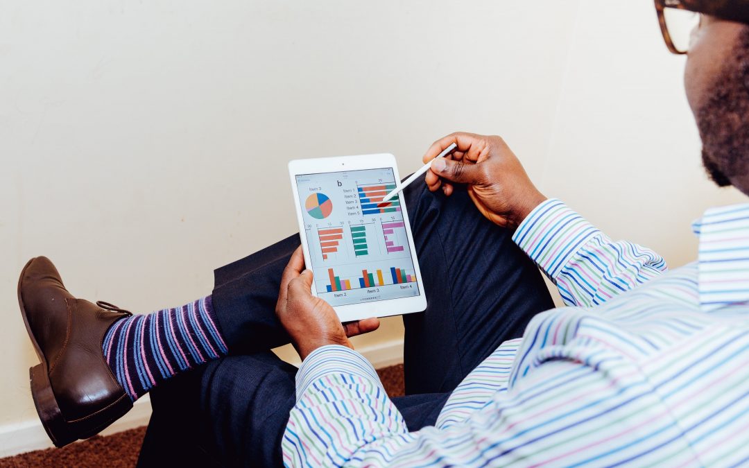 man looking at graph on tablet